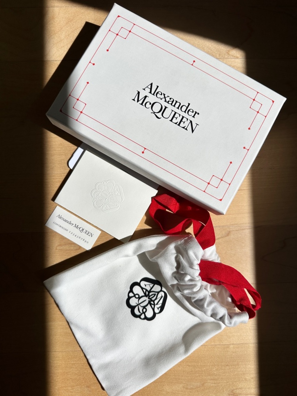 Alexander McQueen White Drawstring Pouch with Red Ribbon and Black Logo